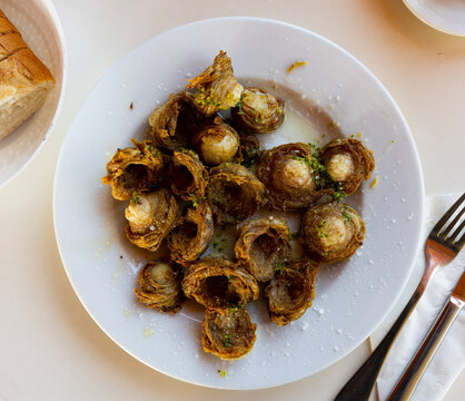 Madejas aragones, traditional Spanish dish made of fried lamb's intestine, served on plate.