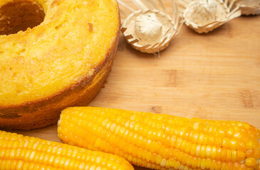 delicious cake and corn on wooden table