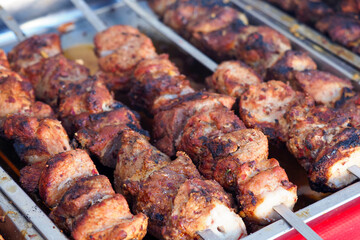 Kebabs on skewers fried on charcoal in the grill, closeup