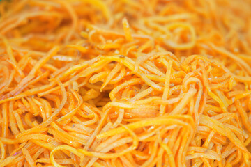 Korean carrot as background. Carrot salad with spices. Carrots in Korean