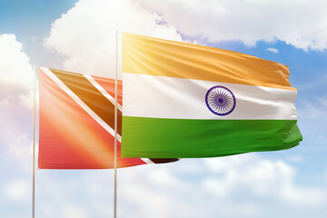 Sunny blue sky and flags of india and trinidad and tobago