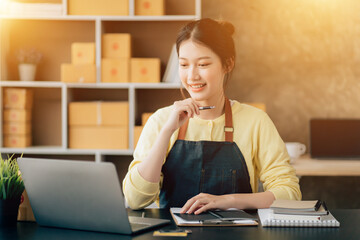 Fototapeta premium Partnership of SME entrepreneur teamwork of small business work at home family online marketing with packing box prepare for deliverty to customers at warehouse home seller office