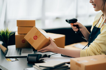 Partnership of SME entrepreneur teamwork of small business work at home family online marketing with packing box prepare for deliverty to customers at warehouse home seller office