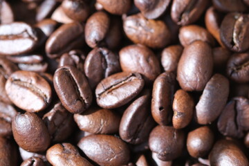 Blurred coffee background. Defocused natural blurred background. Coffee roasted beans closeup, coffee macro close up, selective focus.