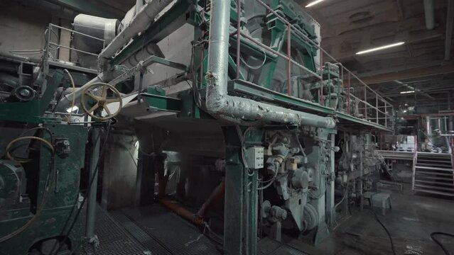 Paper production machine in wastepaper recycling factory. Paper and pulp mill.