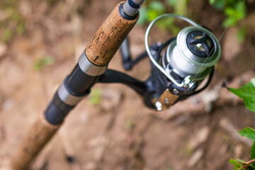 Fishing reel and fishing line close up, summer fishing, leisure activity.