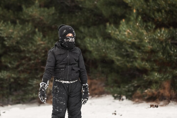 Young boy playing in snowy winter wonderland