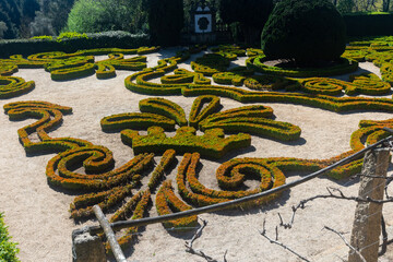 Picturesque landscape park of Mateus Palace with trimmed boxwood bushes creating exquisite green patterns on sunny spring day, Vila Real, Portugal