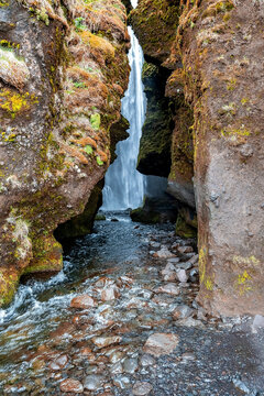 Scenic cascades of Gljufrafoss flowing through stream. Hidden beautiful waterfall in valley. Close-up idyllic view of famous tourist attraction in mountain.