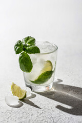 Refreshing infused water with citrus lime and basil. Lemonade drink. Wellness concept