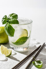 Refreshing infused water with citrus lime and basil. Lemonade drink. Wellness concept