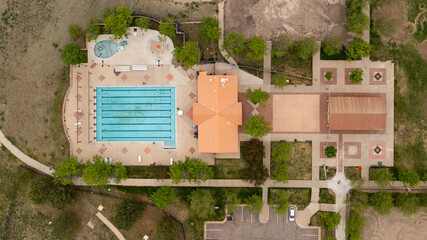 Aerial overhead image of suburban community amenities pool and clubhouse