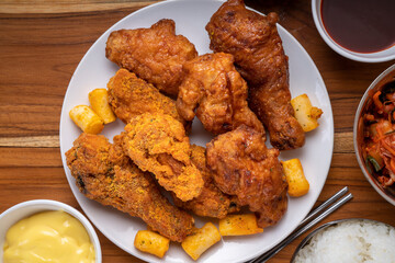 Delicious Korean fried chicken with cheese dipping sauce  traditional Korean food, Fried chicken and korean rice cake with cheese dipping on wooden table.