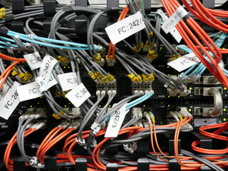 many fiber optic cable network connected to internet switch servers in data center.	
