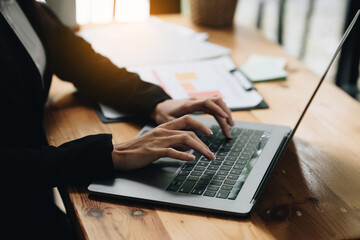 Close up Business woman hand using calculator to calculate on laptop the company's financial results and budget. Account Audit Concept.