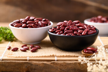 Red kidney beans in bowl on wooden table, Food ingredients