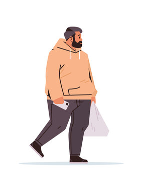 overweight man holding shopping plastic bag and using smartphone while walking vertical