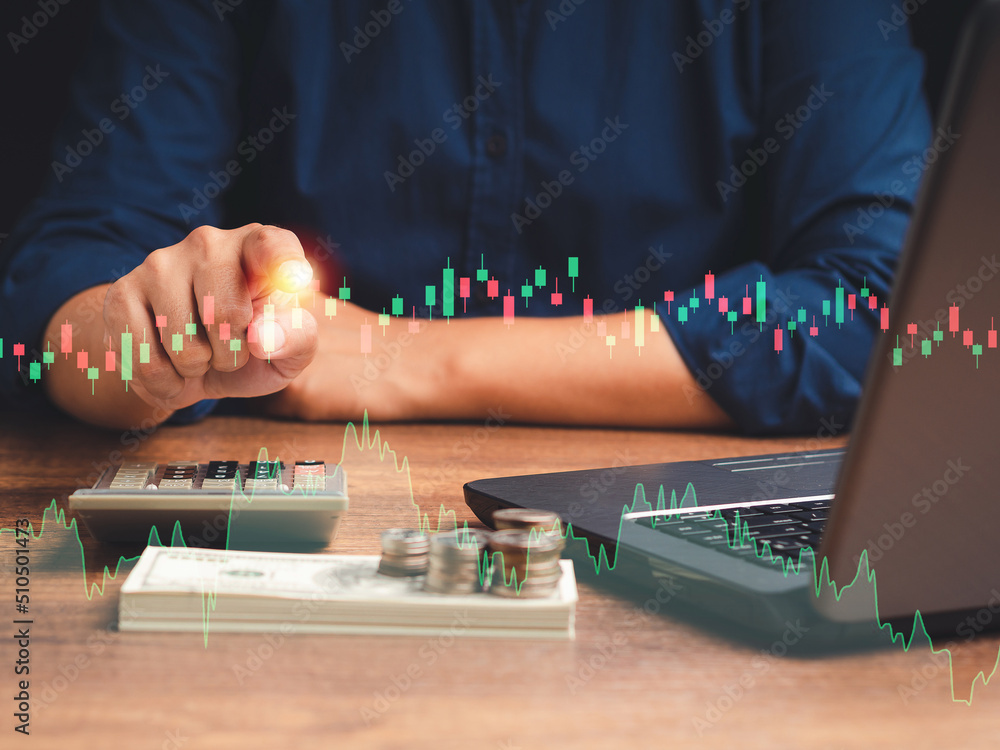 Poster hand of a businessman pointing to graph stock on a virtual screen while sitting in the office
