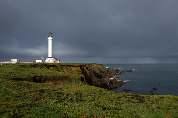 Fototapeta na wymiar Point Arena Lighthouse on beautiful cliffs, California, USA, stormy sky