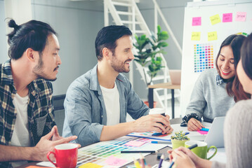 Fototapeta premium Creative design office center working teamwork. Happy business people partner plan strategy organization research people together at diversity office using laptop, smartphone company conference room