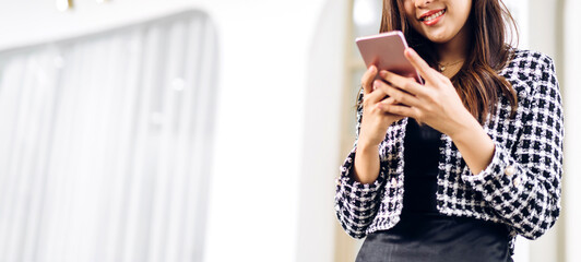 Portrait of smiling happy beautiful asian woman relaxing using digital smartphone.Young asian girl looking at screen typing message and playing game online or social media at cafe