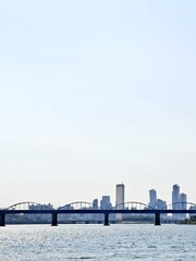 Tied arch bridge over Han River and panoramic view of high rise buildings in Seoul	