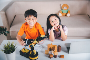Two children programming and testing robot arm their science, Kid little girl program code to robot...