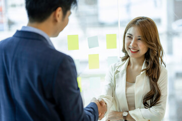 Business people shake hands while finishing up meetings or negotiations in the office. Congratulations handshake for new employees Business handshake and partnership concepts.