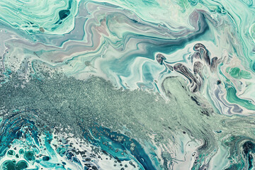 Fluid Art acrylic paints. Abstract mixing blue green waves. Liquid flows splashes. Marble effect background or texture