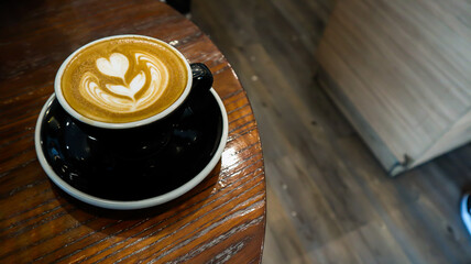a glass of hot cappuccino in a cafe