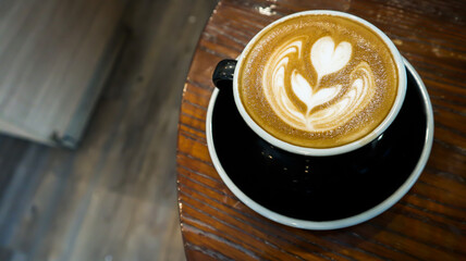 a glass of hot cappuccino in a cafe
