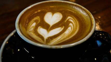 a glass of hot cappuccino in a cafe