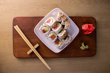 sushi on a plate with chopsticks