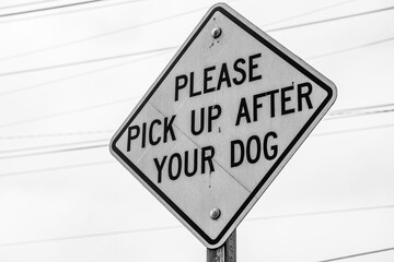 Please pick up after your dog street sign