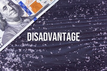 DISADVANTAGE - word (text) on a dark wooden background, money, dollars and snow. Business concept (copy space).