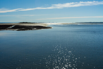 View of the sea from Wellington Point, with King Island in the mid-ground and Port of Brisbane on the horizon. Sunlight sparkling on the water. Queensland, Australia 