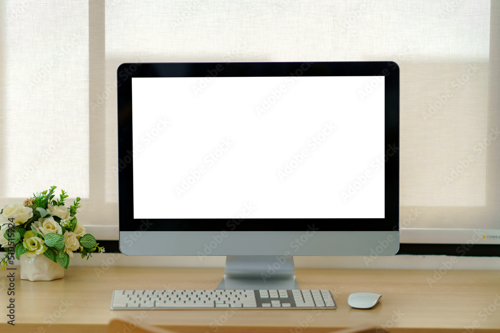 Poster laptop computer with blank white screen on table in the office. mock up.