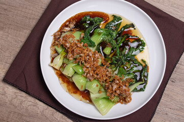 Baby Bok choy or chinese cabbage in oyster sauce with and fried garlic.