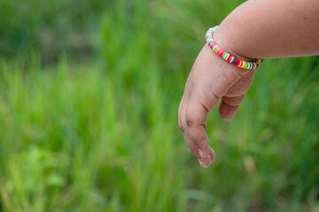 Rainbow bracelet on green background.lgbt concept. happy earth day.copy space