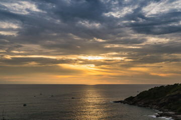 Fototapeta na wymiar The sun is falling in sunset time at Promthep Cape in Phuket, Thailand.