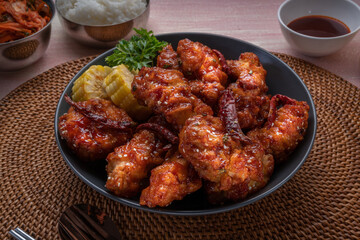 Gang Jeong chicken or crispy and tender Korean fried chicken smothered in a sticky, spicy red sauce Served with kimchi, dipping sauce, rice and sweet corn.