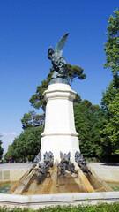 Fototapeta na wymiar The fountain of the Fallen Angel or monument of the Fallen Angel is located in the Retiro Park in the town of Madrid, in the traffic circle of the Fallen Angel. It is the work of Bellver and Jareño.