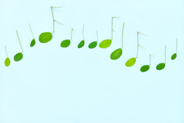 Fresh refreshing and spring summer music concept. Creative composition of fresh leaves arranged into musical notes.