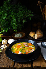 Hearty rustic pea soup with bacon and sausage