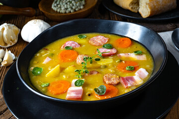 Hearty rustic pea soup with bacon and sausage