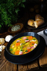 Hearty rustic pea soup with bacon and sausage