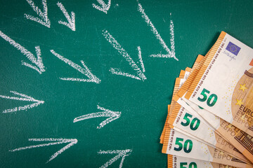 Euro money on a green chalkboard. Follow money concept