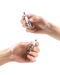 The hand holds a new and used iridium spark plugs. Close up. Isolated on a white background.