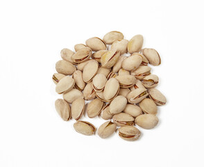 Pile of pistachios isolated on white background. Closeup of pistachios in the peel