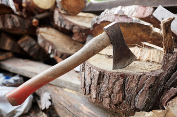 Ax in the stump. Axe for cutting wood. Preparation of firewood for the winter. Selective focus, blurred background